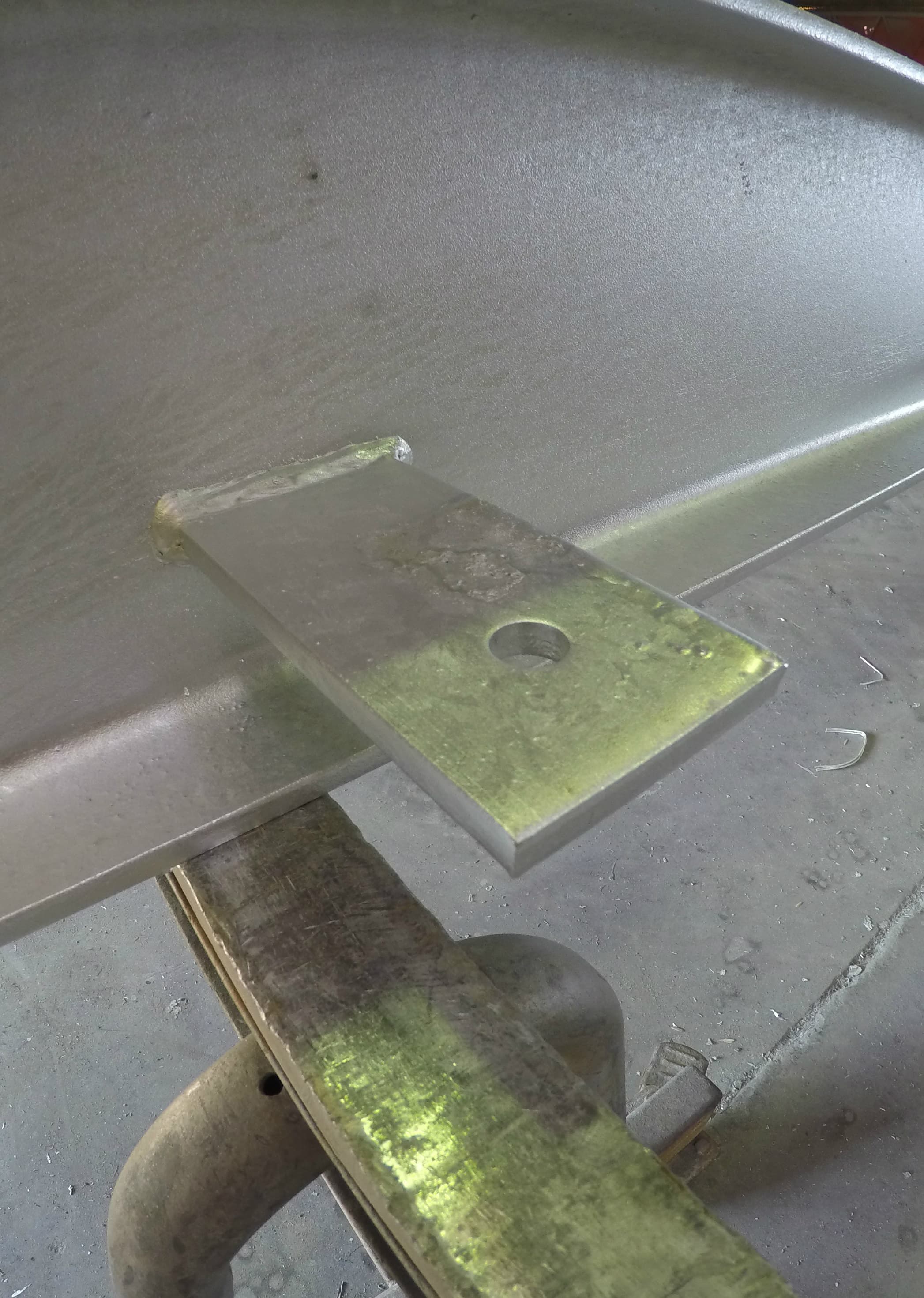 Before/after of galvanized bracket with ash removed