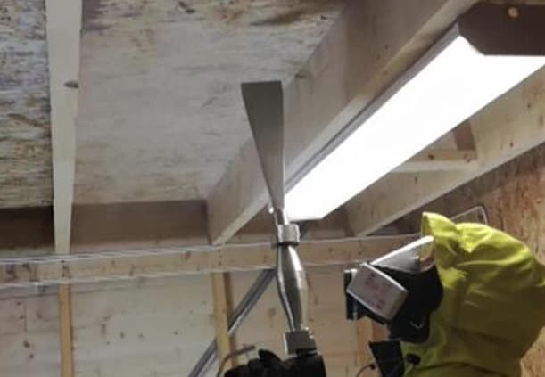 Before/after view of roof sheathing after dry-ice cleaning
